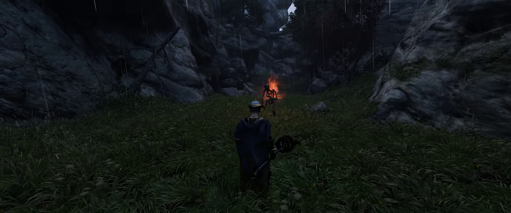Enshrouded player facing a summoned skeleton in a grassy ravine during rainfall, with the skeleton glowing red ahead.