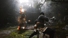 The Destined One in Black Myth: Wukong engaging in combat against a large armored boss holding a flaming staff in a dense, sun-drenched forest.