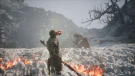 The Destined One from Black Myth: Wukong wielding a glowing fire staff against an enemy in a snowy, mountainous environment.