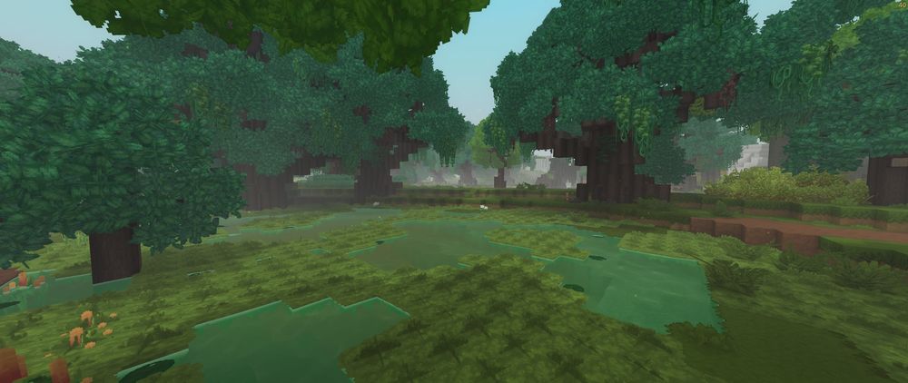 The Fens biome in Hytale showing a dense swamp environment with shallow water, large trees, and lush green vegetation.