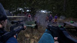 First-person view of soldiers facing a zombie horde in a forest, firing rifles amid smoke, with a green ammo box on a bench.