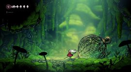 A small character with a red cloak stands in a lush, green, mystical forest near a large, ornate, spherical cage.