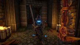 A player character in Everwind wearing glowing blue-accented armor and holding a large sword, standing inside a stone brick corridor with torches and mechanical gears.