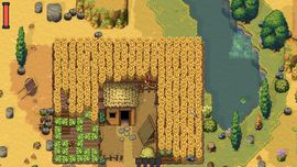 Top-down pixel-art gameplay screenshot from Romestead showing a large, golden wheat field surrounding a small wooden house with a thatched roof, enclosed by a wooden fence.