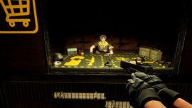 First-person view: gloved hands with a pistol; a trader with a yellow scarf sits behind a weapons-filled table in a dim armory.