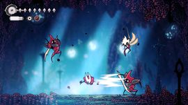 A scene from a video game showing a character battling three armored enemies in a mystical, glowing cave environment.