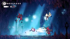 A scene from a video game showing a character battling three armored enemies in a mystical, glowing cave environment.