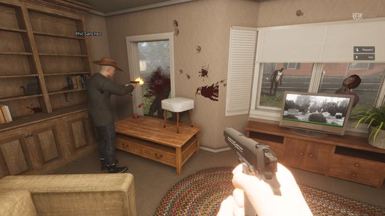 Two people in a living room with a glass door. there's a coffee table blockading the doorway with someone shooting what looks like a zombie through it. POV person is aiming their gun towards the same enemy. There's a couple of zombie looking folk shambling about outside of the window.