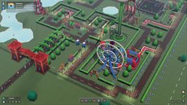 A colorful top-down view of a theme park creation in s&box, featuring a blue Ferris wheel, green brick-paved paths, and red industrial buildings.