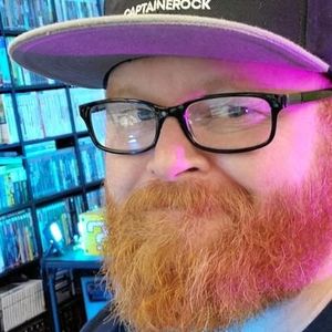 erock wearing black glasses and black cap.